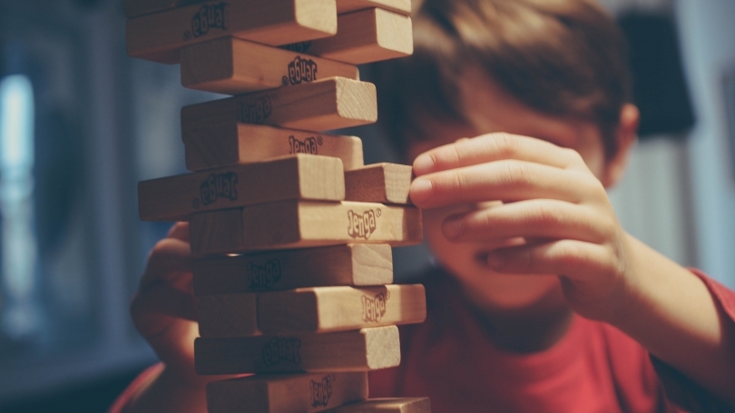 A child plays Jenga.